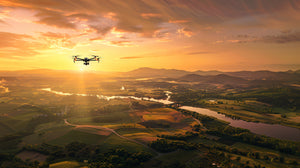 A drone flying over a bird's-eye view of a rural landscape with a picturesque sunset.