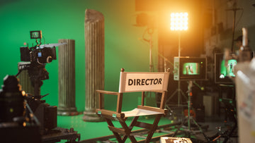 behind the scenes of a set, with a directors chair, cameras and lights