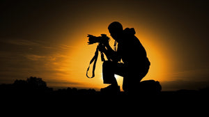 Silhouette of a man with a film camera 