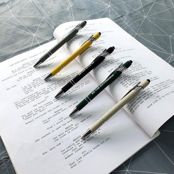 open two page script book with the five affirmation pens lined up in a diagonal formation 