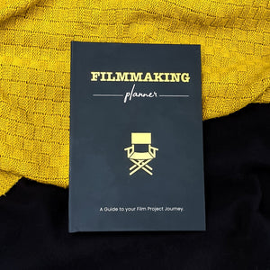 Yellow and black, A5, Matte Filmmaking Planner against yellow and black material 